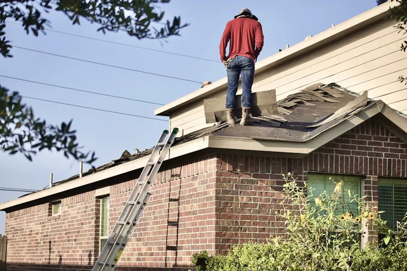 Professional roofer working on a residential roof in Tellico Village